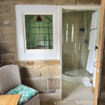 Bathroom with stained glass window and walk in shower